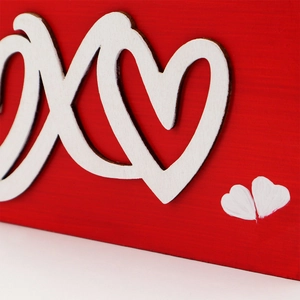 XOXO wooden Valentine decor featuring red base and white 3D heart-shaped ornaments