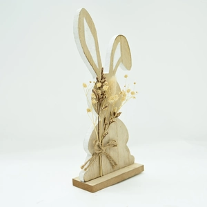 Close-up of wooden Easter bunny decor with natural dried flowers and jute bow detail