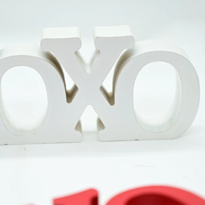 Close-up of minimalist white OXO decorative letter ornaments for wedding table decor
