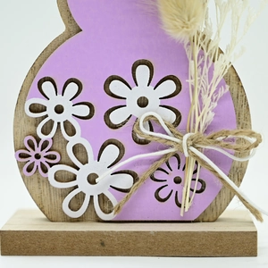 Macro detail of wooden Easter bunny decor with purple finish, daisy cutout and jute bow