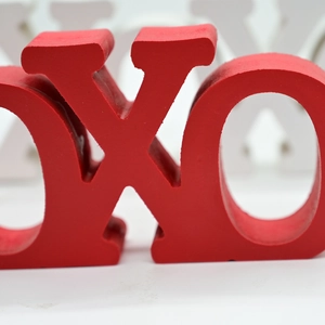 Close-up of red and white wooden XO letter ornaments for romantic home table decor