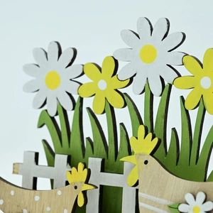 Macro detail of multi-layered Easter wooden chick ornament with daisy and fence texture
