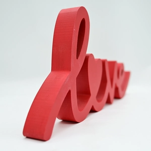 Close-up of red wooden Love lettering ornament for romantic home and wedding decor