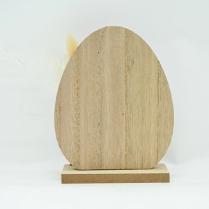Macro view of egg-shaped wooden Easter ornament on a rectangular base with natural grain