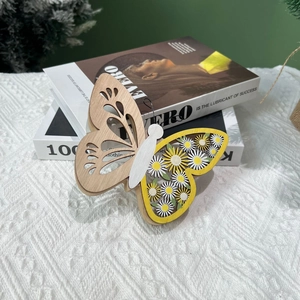 Détail d'un ornement papillon en bois avec motifs marguerites et sculptures évidées