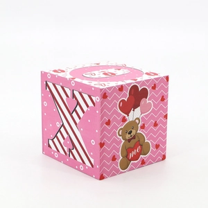 Detail of pink block decor with dotted pattern, teddy bear illustration, and letter X