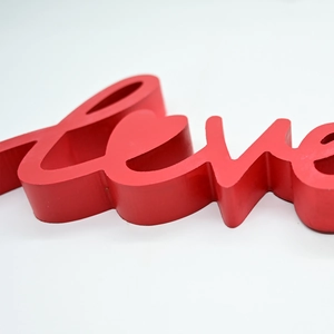 Detail of red matte wooden Love sign for Valentine's Day and wedding home decoration