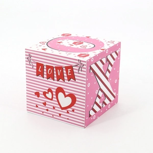 Detail of a square Valentine wooden block with pink stripes and LOVE banner lettering