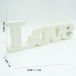 Detail view of white wooden LOVE letter sign for wedding and home decor