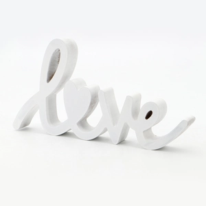 Detail view of a white wooden LOVE sign with heart-shaped O for home table decor