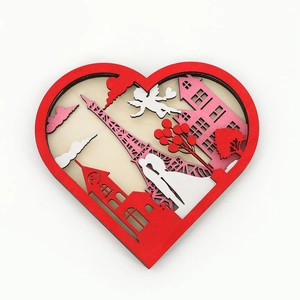 Detail of 3D layered wood heart ornament featuring Eiffel Tower and romantic couple