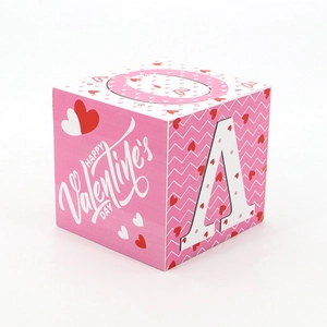 Macro shot of pink wooden block with wave texture and Happy Valentine's Day printing