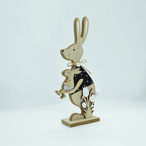 Detail of wooden Easter bunny figurine featuring a polka dot outfit and jute rope bow
