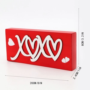 Macro side view of red wooden XOXO block sign with white heart details and dimensions