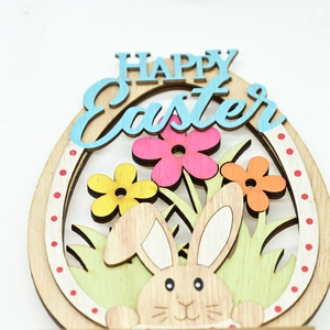 Detail of wooden Happy Easter egg ornament with colorful floral patterns and rabbit