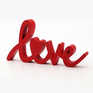 Detailed view of red wooden LOVE sign with heart shaped O for wedding home decor