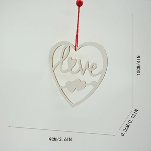 Macro detail of wooden heart pendant with Love carving and red bead hanging rope