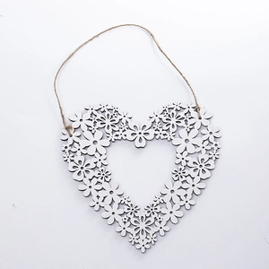 White heart-shaped wooden wreath with floral cutout patterns and natural jute rope