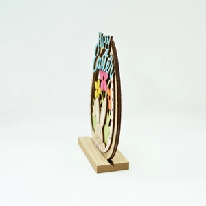 Detailed side view of multi-layered laser-cut wooden Happy Easter egg table ornament