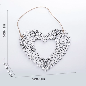 Hollow heart wreath wall decor with white floral patterns and hemp rope hanging