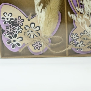 Wooden Easter bunny and butterfly ornaments with purple edges in a kraft gift box