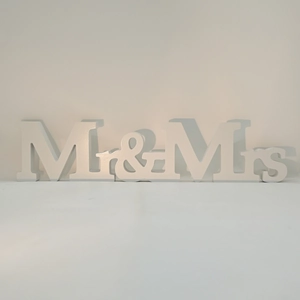 Close-up of white wooden Mr & Mrs standing letters for wedding decor and tabletop display