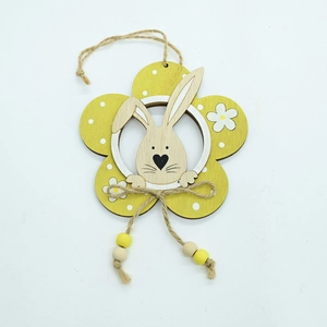 Detail of wooden Easter rabbit pendant with yellow flower design and jute rope