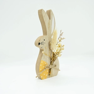 Detail of wooden Easter bunny decor with natural dried flowers and jute rope bindings