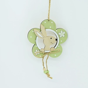 Detailed view of green wooden flower ornament with polka dots and small wooden rabbit
