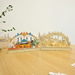 Detail of wooden LED moon lamps with laser-cut mosque design and warm ambient glow