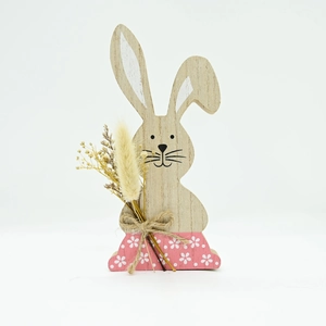 Detail of wooden Easter bunny with dried flowers and rustic hemp rope decoration
