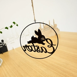 Detail of black metal Easter wreath with rabbit silhouette and artistic Easter text