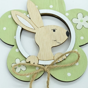 Detail of wooden Easter pendant featuring a green flower base and a natural wood rabbit