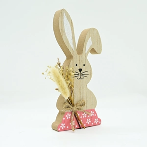 Close-up of Easter wooden bunny with dried flowers and rustic floral painted base