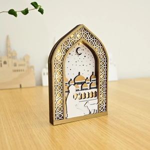 Close-up of wooden LED lantern with intricate laser-cut Eid mosque and moon silhouette