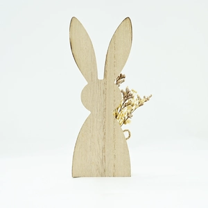 Detail of wooden Easter bunny ornament with smooth texture and dried flower decoration