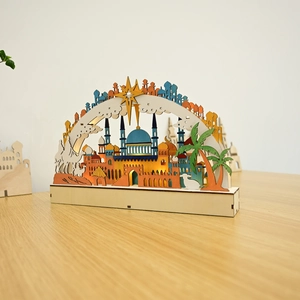 Detail of wooden LED moon lamp with laser-cut mosque and camel silhouette design