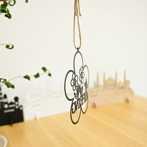 Close-up of black metal floral wreath with SPRING cutout and rustic jute rope hanging