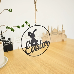 Detail of metal Easter wreath hanging with rabbit silhouette and artistic lettering