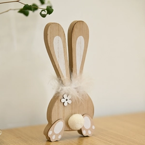Detail of wooden Easter bunny decor with fluffy white feather neck and pom-pom tail