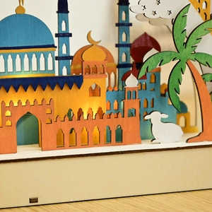 Detail of multi-layer wooden Ramadan moon lamp with mosque silhouette and warm LED light