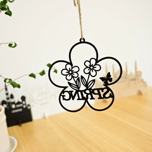 Detail of metal floral wreath with bird and SPRING laser-cut hanging garden decoration