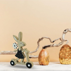 Nordic Easter wooden bunny on a scooter with polka dot dress for home table decor