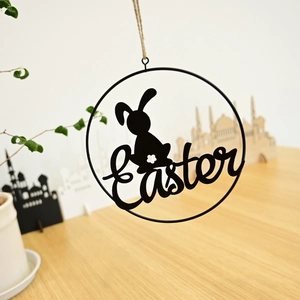 Close-up of black metal Easter wreath featuring a rabbit silhouette and rope hanger