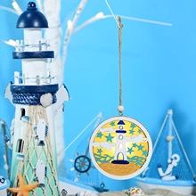 Detail of nautical wooden LED pendant with lighthouse carving and warm yellow light