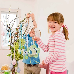 Easter wooden bunny flower ornament hanging on a festive tree branch with light green beads