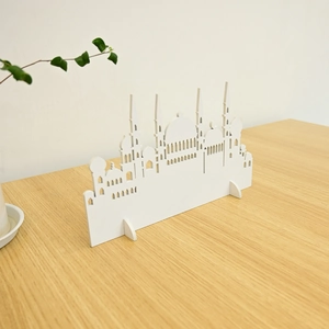 Macro detail of white laser-cut wooden Muslim mosque silhouette table ornament