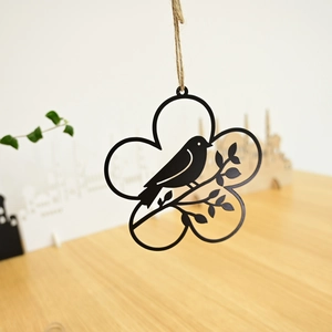Detail of black metal Easter wreath with bird silhouette and rustic jute twine