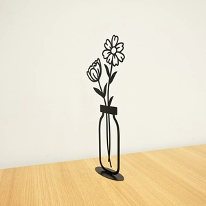 Detail of minimalist black metal line art daisy in vase sculpture for wall or table decor