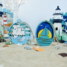 Detail of nautical wooden ornaments with sailboat designs on a beach setting